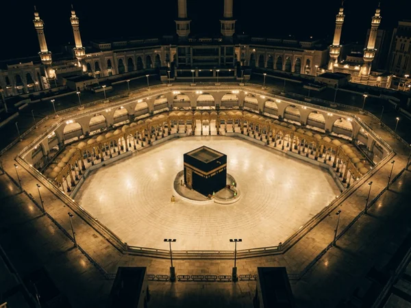 Aerial night view of the Kaaba and the Mataf courtyard under warm floodlights