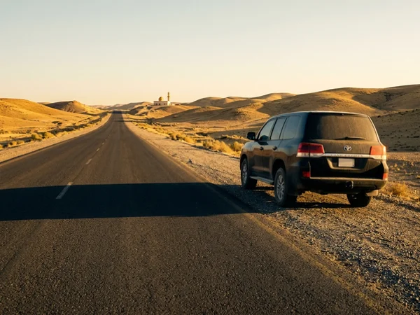 Transfer vehicle on a desert highway at golden hour