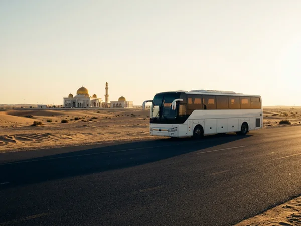 Air-conditioned coach parked on a Saudi road at golden hour