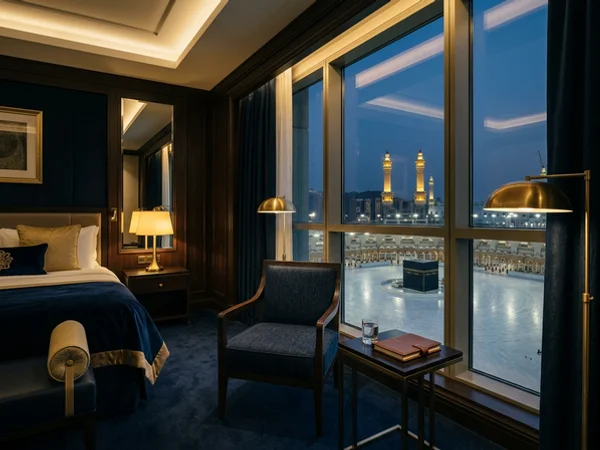 Makkah hotel room with a window overlooking the Haram courtyard at dusk