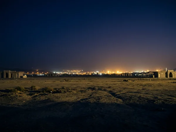 Muzdalifah open ground under a pre-dawn indigo sky