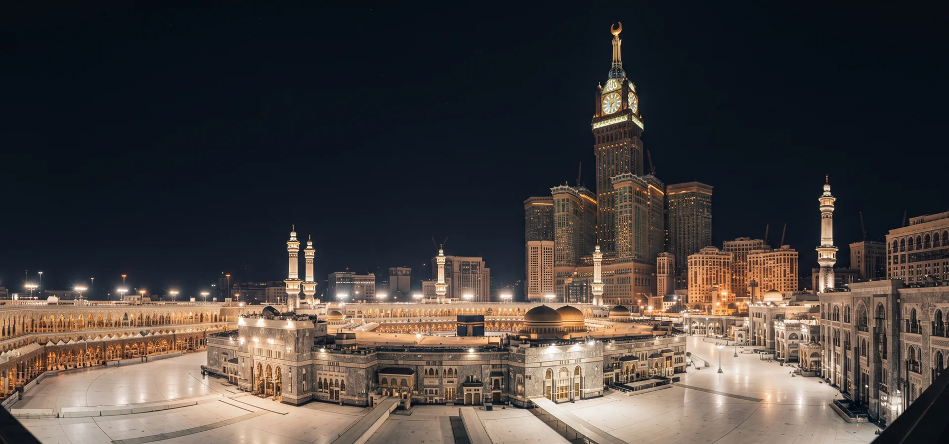 Illuminated clock tower complex above the Haram at night