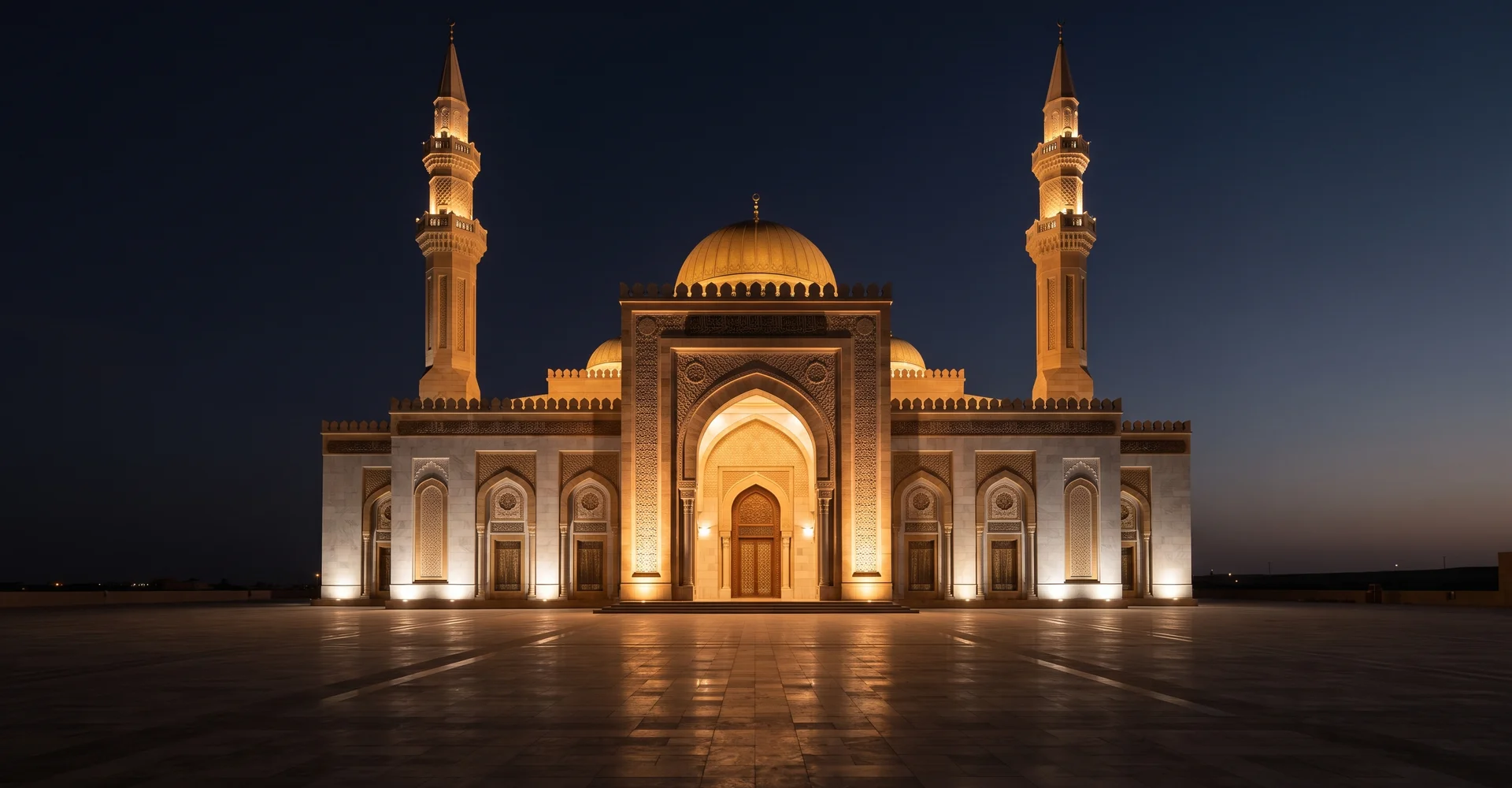 Symmetrical mosque facade with twin minarets lit at evening