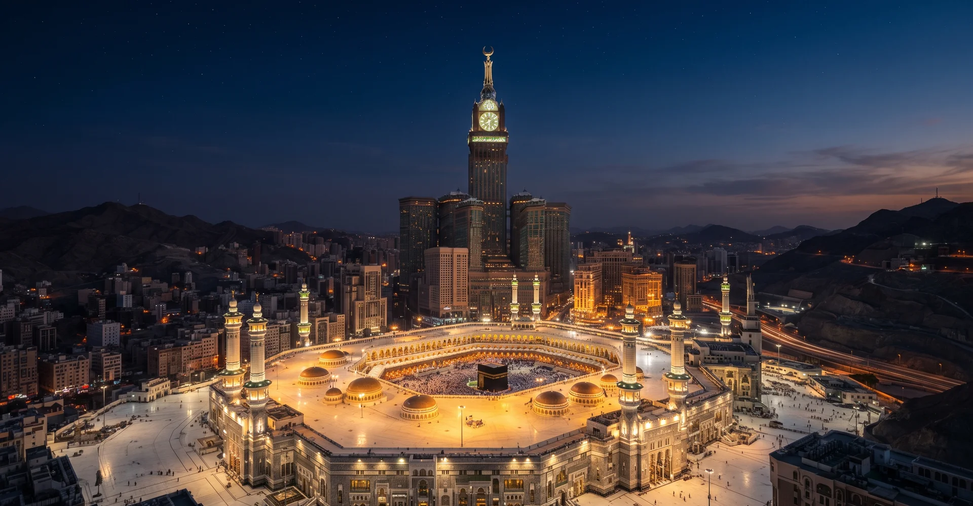 Twilight aerial view over Makkah with the illuminated Clock Tower complex and Haram courtyard