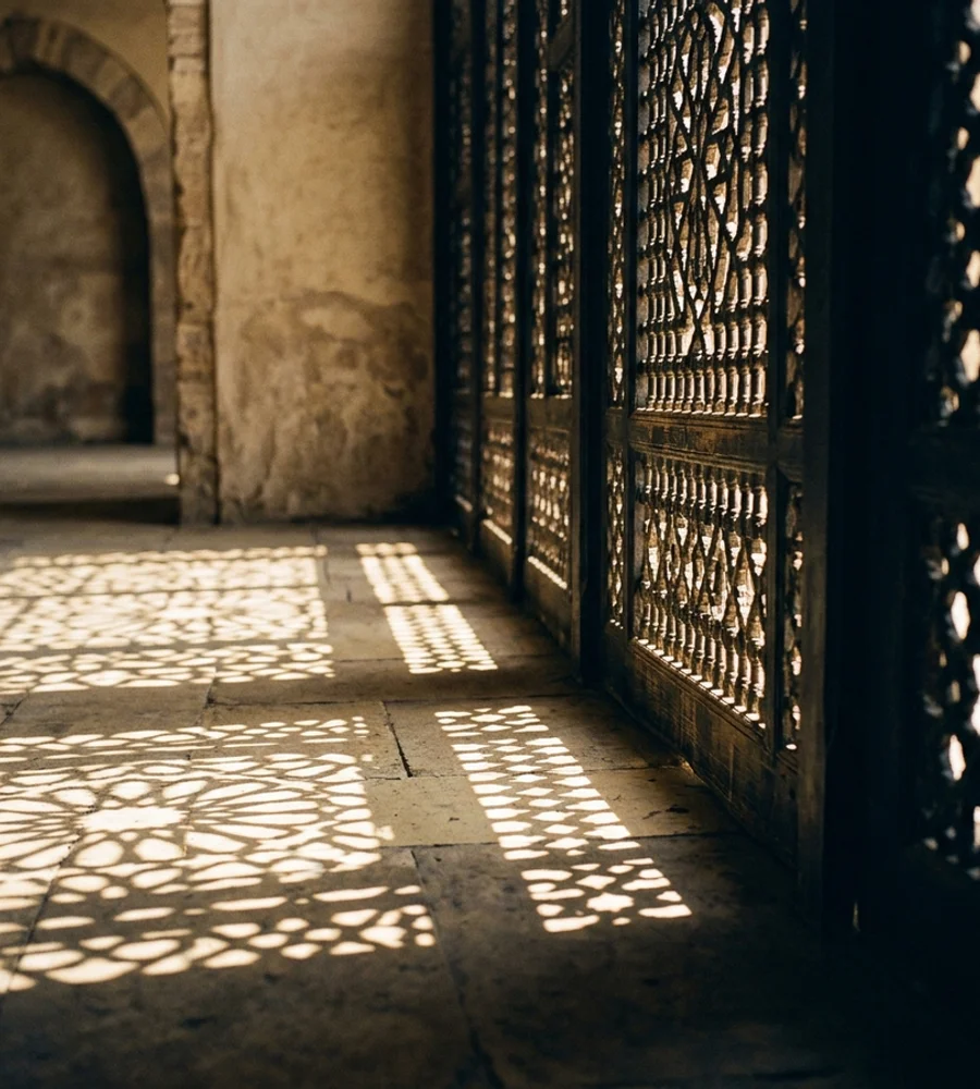 Latticed wooden screen casting shadow patterns on a stone floor