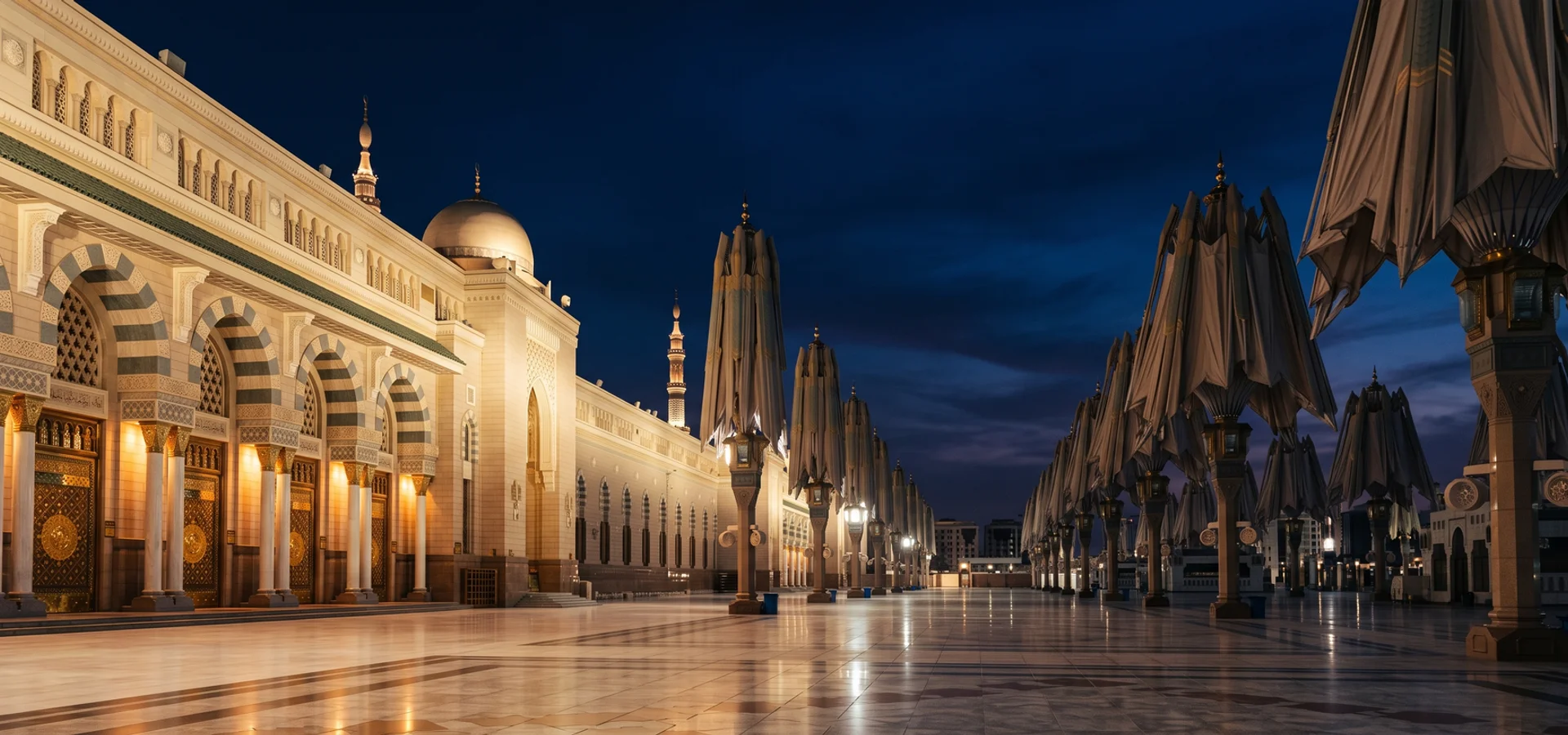 Mosque plaza with shade canopies under a deep blue evening sky