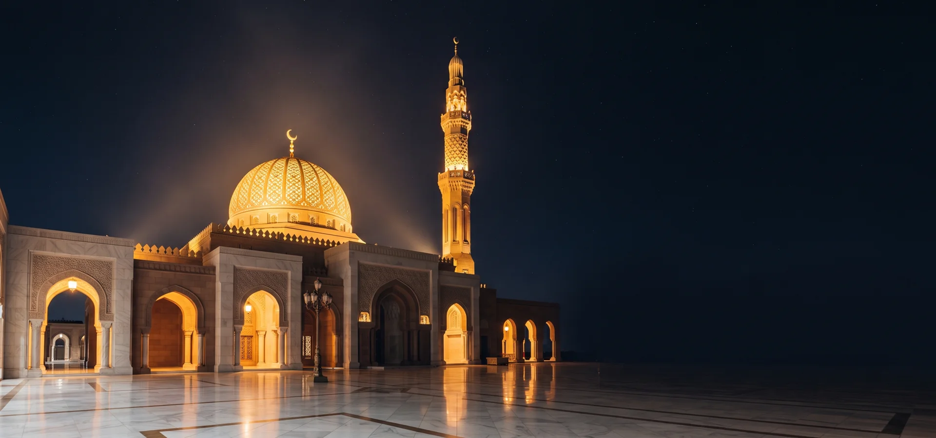 Illuminated mosque dome and minarets glowing against a deep navy sky